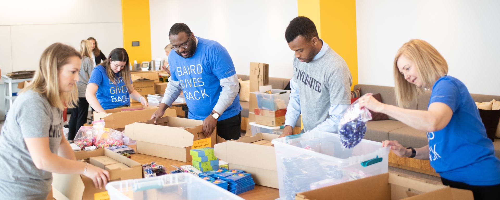 Group of Baird Associates packing food boxes.